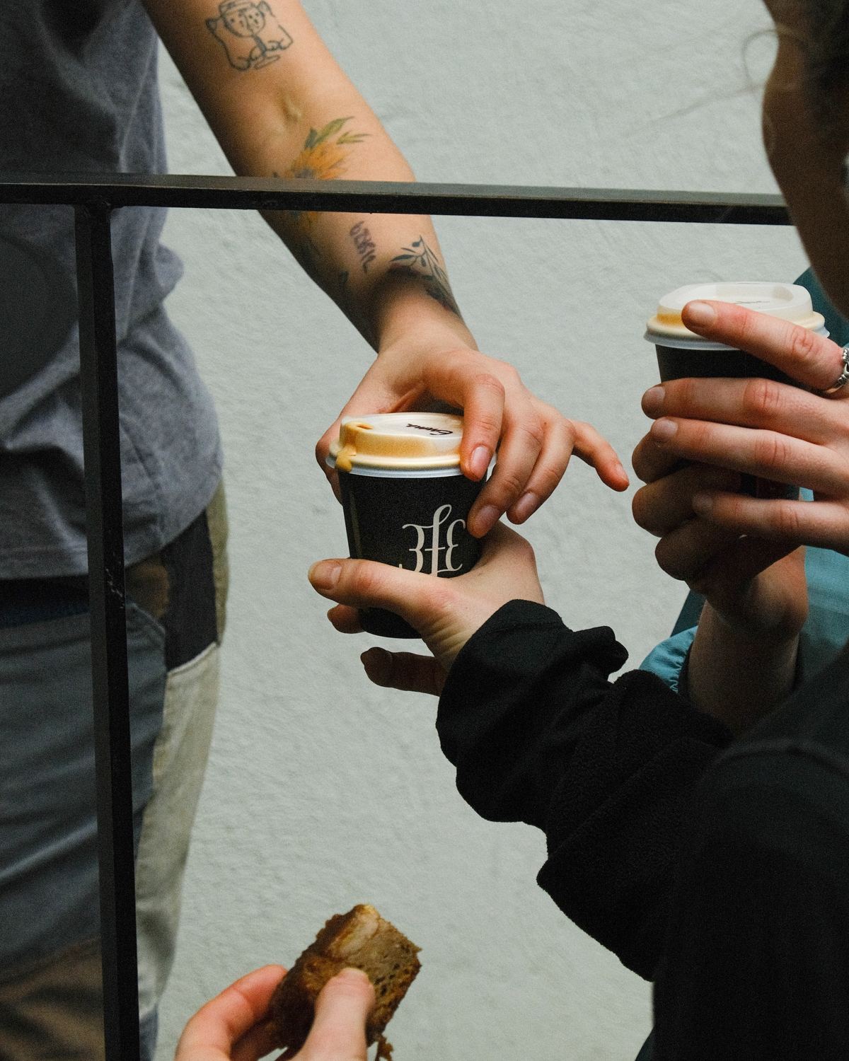 Members passing 3fe coffees and a pastry after a run.