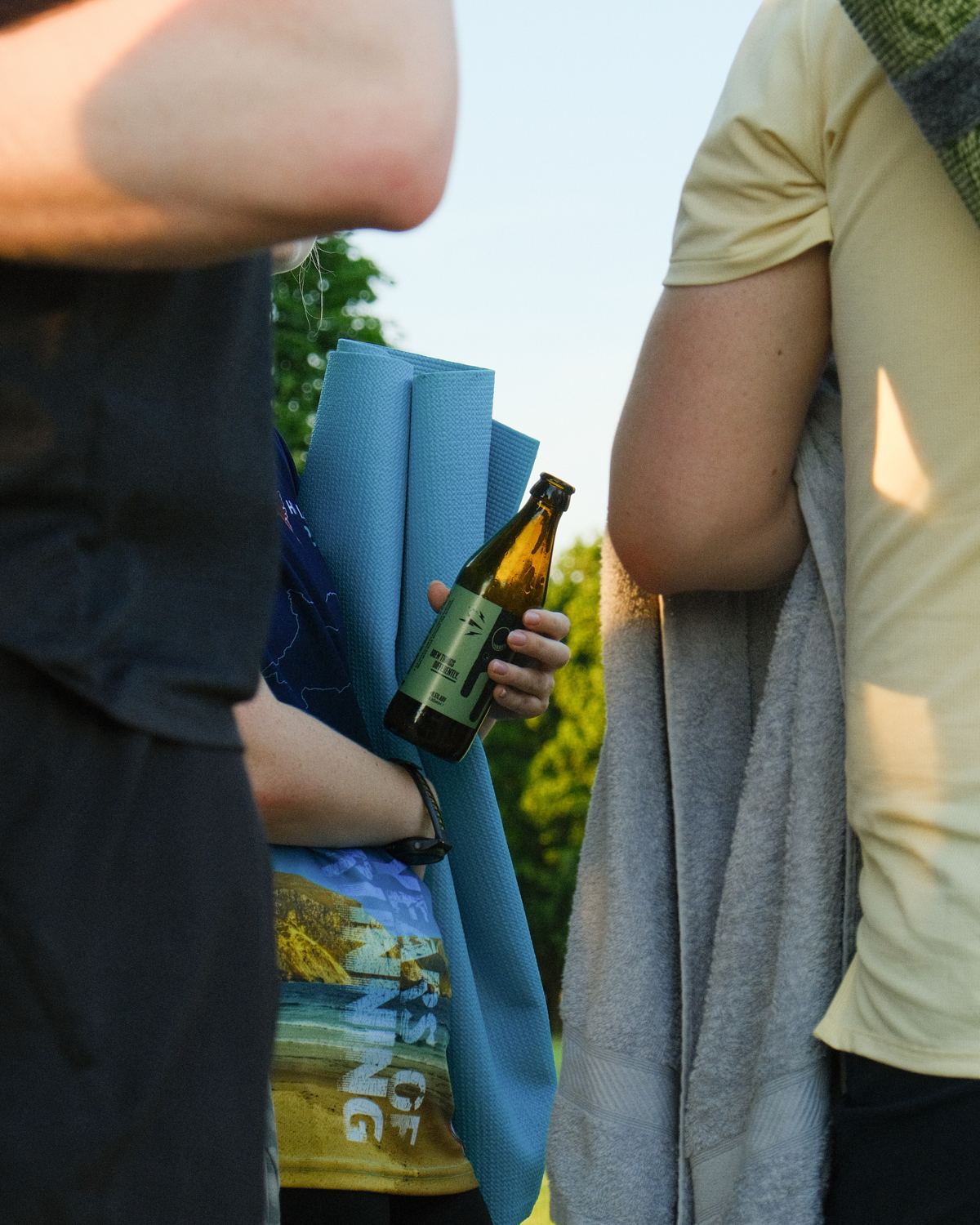 A member holding a Fierce Mild and a yoga mat after a class.